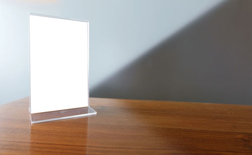 Close-up of blank placard on wooden table