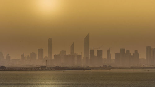 Golden hour on the skyline of a modern city. sunrise over high buildings near the ocean in uae. 