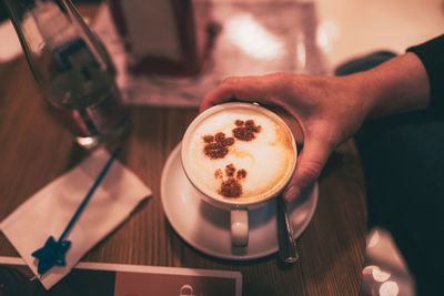 Cropped hand holding coffee