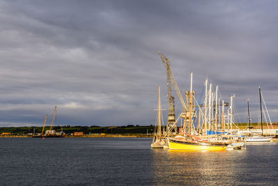 Sailboats in sea against sky