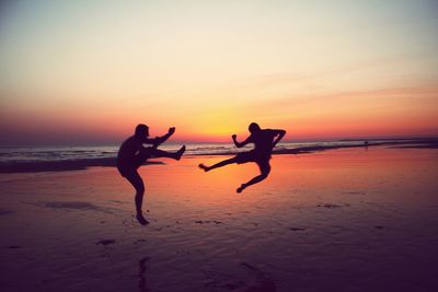 People on beach at sunset
