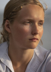 Close-up of girl looking away in sunny day