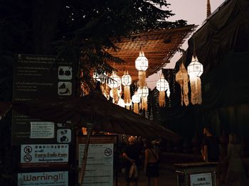 Low angle view of illuminated lanterns hanging in building