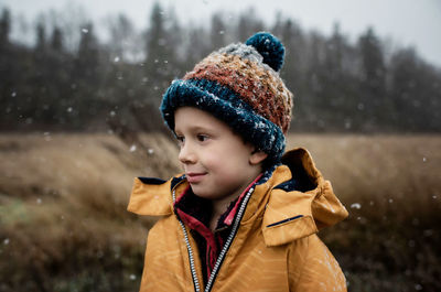 Portrait of boy looking away in snow