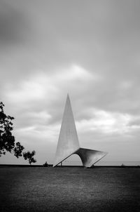 Built structure on field against sky