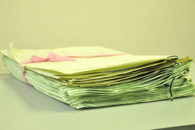 Close-up of stacked yellow papers on table