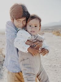 Portrait of two kids hugging in the desert