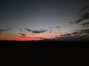 Silhouette landscape against sky at sunset