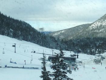 Scenic view of snow covered mountains against sky