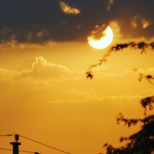 Low angle view of sun in sky during sunset