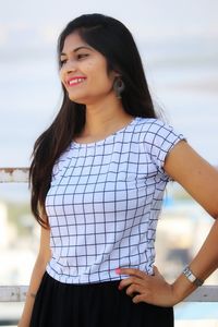 Portrait of a smiling young woman standing outdoors