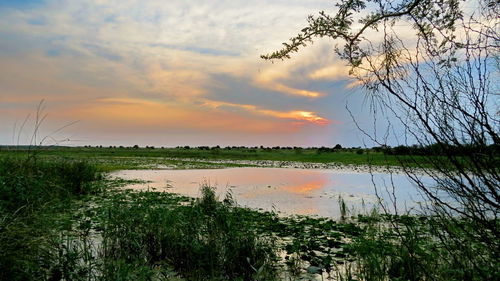 Scenic view of lake against sky during sunset