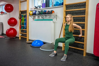 Rear view of man exercising in gym