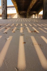 Shadow of bridge on road