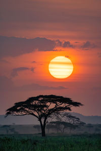 Scenic view of field against romantic sky at sunset