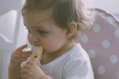 Close-up of cute girl eating food