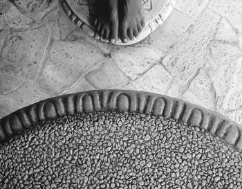 Low section of woman standing on tiled floor