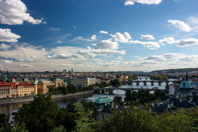 Buildings in town against cloudy sky