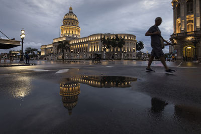 Reflection of building in puddle