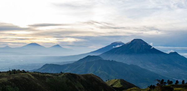 Scenic view of mountains against cloudy sky