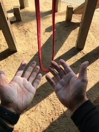 Close-up of hands on sand