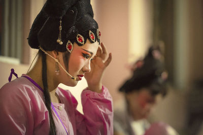 Portrait of young woman looking away at home