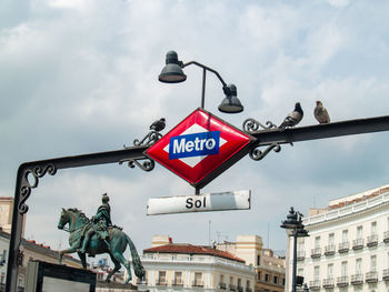 Low angle view of road sign against sky