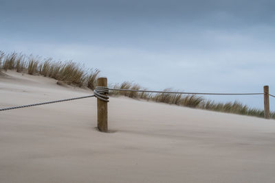 Snow on beach against sky