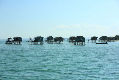 Scenic view of sea and houses against sky