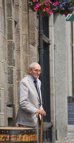 Low angle view of man standing against building