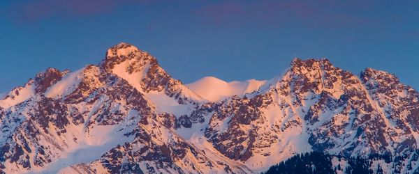 Snowy mountains at sunset