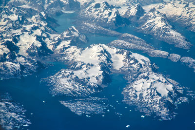 Aerial view of snowcapped mountains and sea