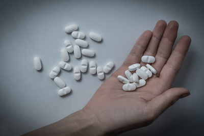 High angle view of human hand against white background