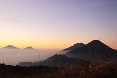 Scenic view of mountains against clear sky during sunset