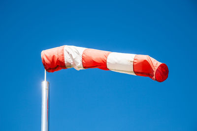 Low angle view of american flag against clear blue sky