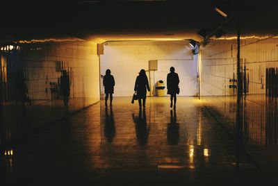 Silhouette women walking in subway