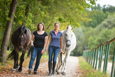 Portrait of friends riding horse