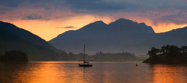 Scenic view of silhouette mountains against sky during sunset