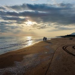 Scenic view of beach against sky during sunset