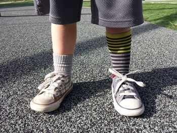 Low section of boy standing on ground