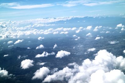 Aerial view of sea against cloudy sky