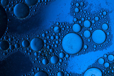 Abstract background of blue oil bubbles . macro shot 