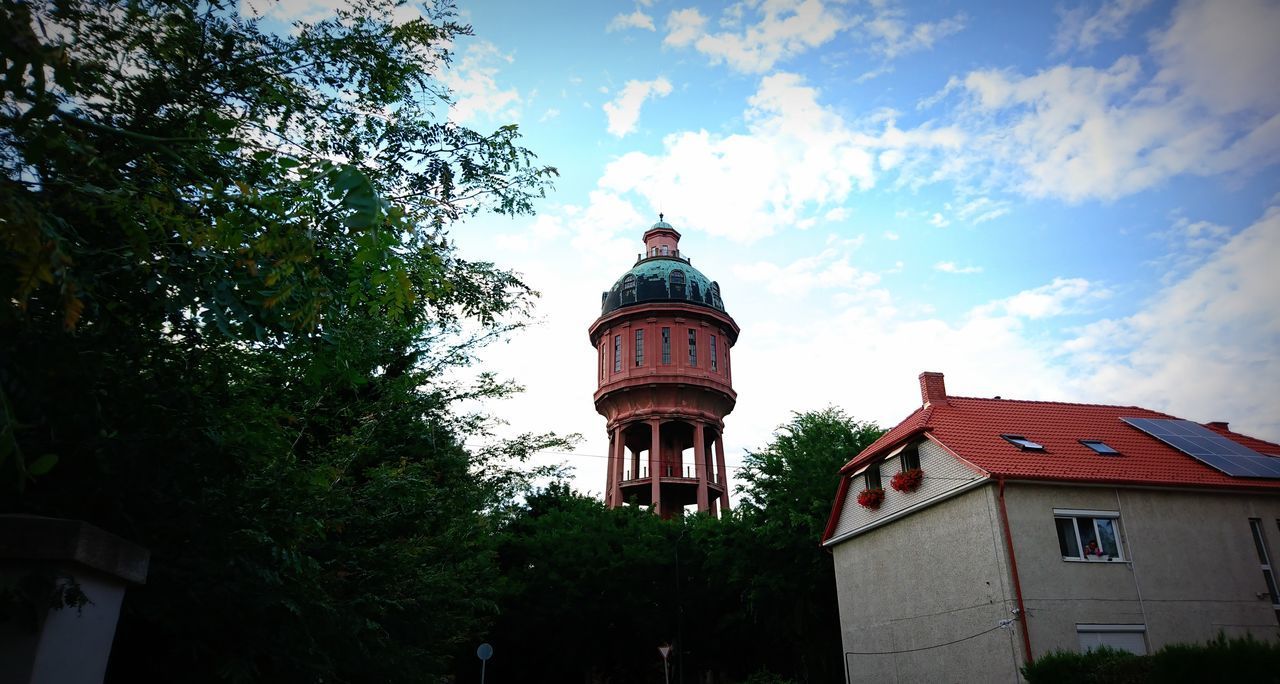 LOW ANGLE VIEW OF BUILDING BY TREES AGAINST SKY