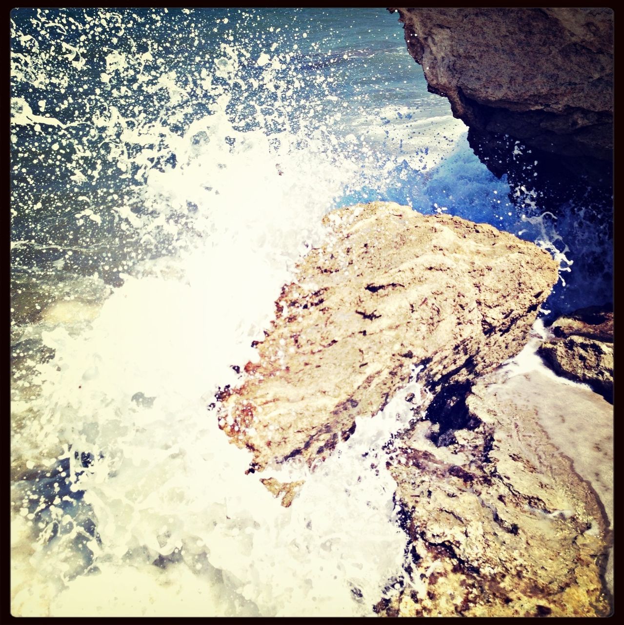 water, transfer print, high angle view, rock - object, auto post production filter, sea, rock formation, nature, rock, tranquility, day, beauty in nature, outdoors, surf, shore, beach, no people, wave, waterfront, rippled