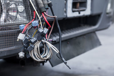 Close-up of a bunch of black wires - wiring a truck against a black bumper background