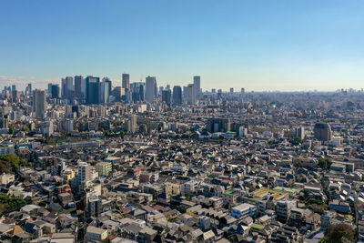 High angle view of modern buildings in city against clear sky