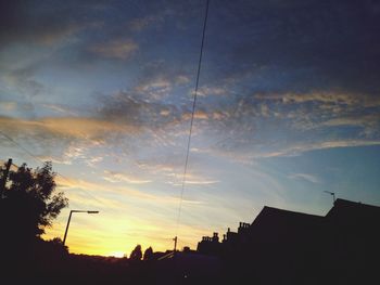 Low angle view of silhouette trees against sky at sunset