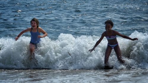 Full length of children on sea shore