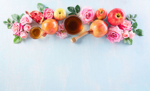 High angle view of pink roses in vase on table