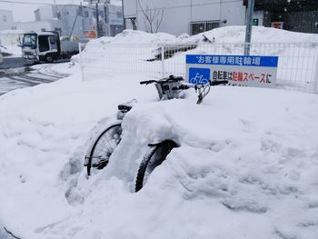 Bicycle on snow covered car